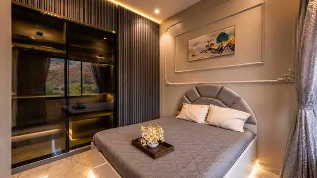 Master bedroom with glass-front wardrobe in the sample flat